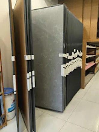 Large dark-grey laminate panels standing on edge against the showroom wall.